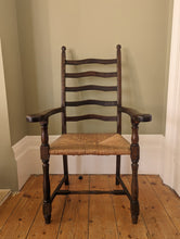 Load image into Gallery viewer, large oak ladder back rush seat on wooden floor
