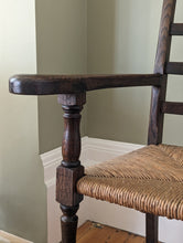 Load image into Gallery viewer, close up large oak ladder back rush seat on wooden floor