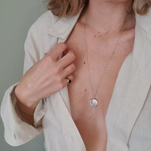 silver pendant on woman