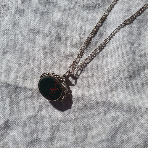 antique silver necklace on linen