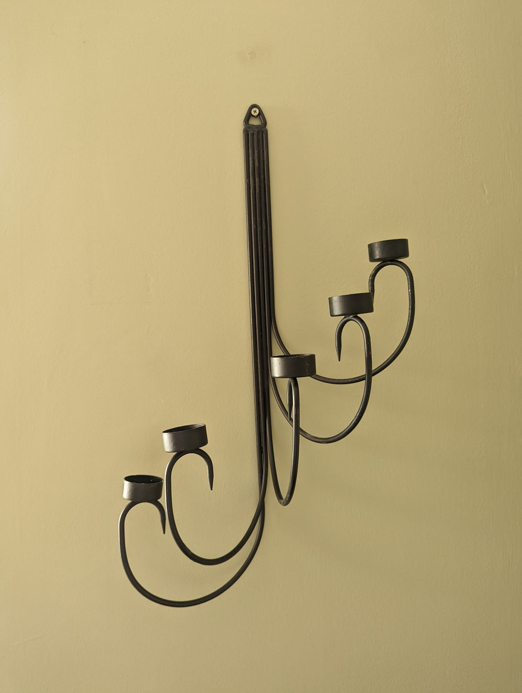 A pair of black metal tealight wall sconces