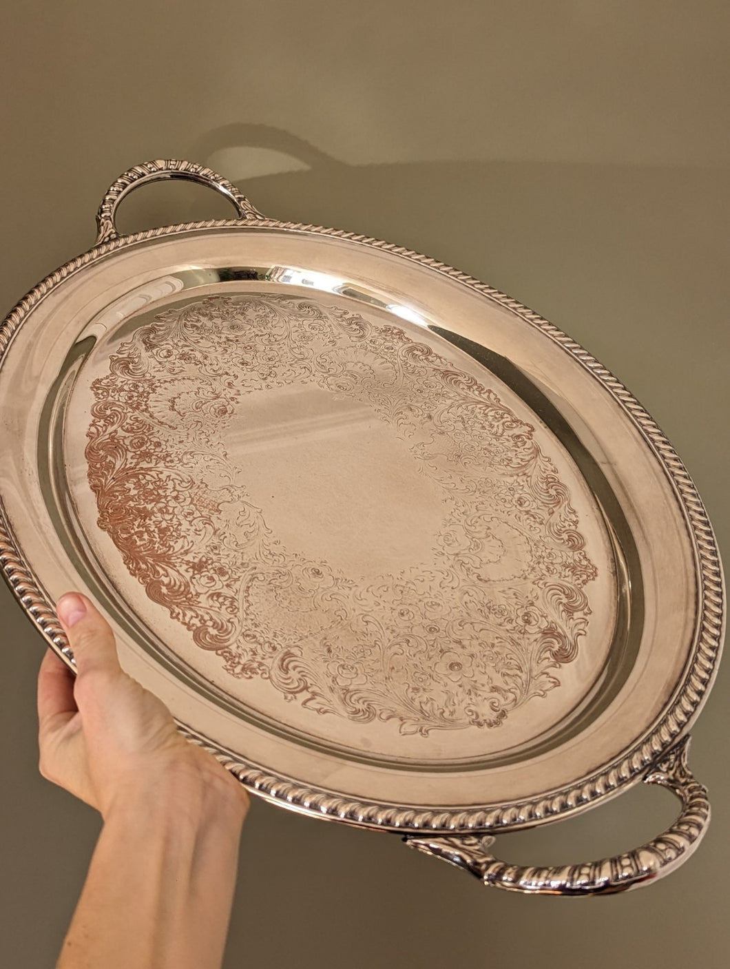 silver tray being held by hand