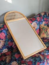 Load image into Gallery viewer, cane and bamboo mirror on floral sofa
