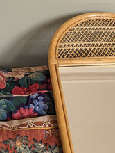 Load image into Gallery viewer, cane and bamboo mirror on floral sofa
