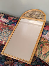 Load image into Gallery viewer, cane and bamboo mirror on floral sofa
