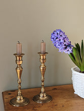 Load image into Gallery viewer, etched brass candlestick holders on shelf with flower in pot
