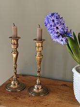 Load image into Gallery viewer, etched brass candlestick holders on shelf with flower in pot
