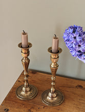 Load image into Gallery viewer, etched brass candlestick holders on shelf with flower in pot
