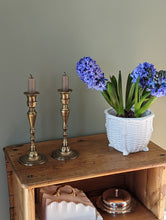 Load image into Gallery viewer, etched brass candlestick holders on shelf with flower in pot
