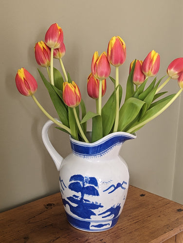 blue and white jug with orange tulips