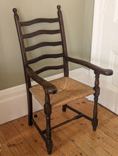 Load image into Gallery viewer, large oak ladder back rush seat on wooden floor
